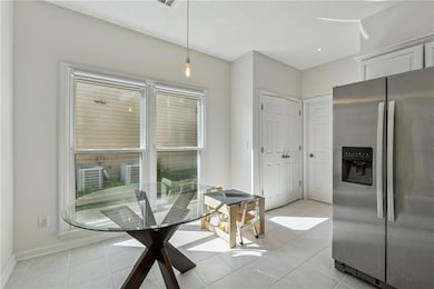Dining space with light tile patterned floors, ple