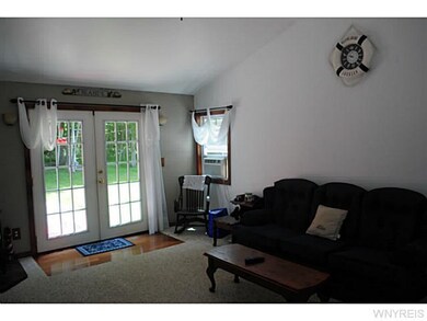 Living Room French doors open to wooded back yard