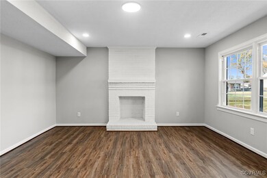 Unfurnished living room with dark hardwood / wood-