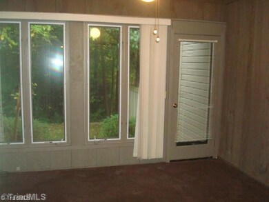 Enclosed Porch. Enclosed porch features large windows, carpeting, and a great view of the back yard.