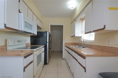 Gally kitchen with lots of cabinets, newer microwave, refrigerator and range.  Plus adjoining big laundry room with new water heater and lots of room for your washer/dryer.