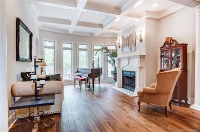 Great room with coffered ceiling, beautiful hardwo