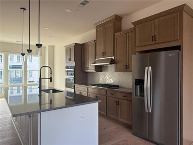 Kitchen featuring visible vents, a center island w