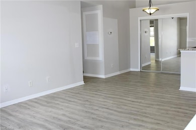 Empty room with baseboards and wood finished floor
