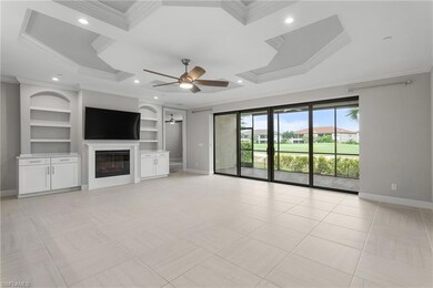Unfurnished living room with crown molding, baseboards, built in shelves, ceiling fan, and a glass covered fireplace