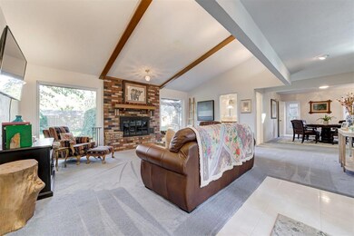 Living room featuring vaulted ceiling with beams, 