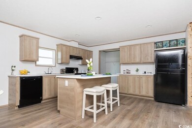 Kitchen with black appliances, light brown cabinet