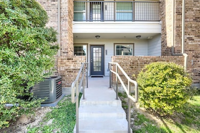 View of exterior entry with a balcony, cooling uni