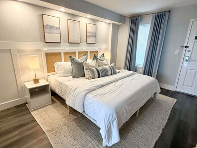 Bedroom with dark wood-type flooring