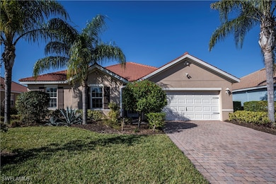 Ranch-style home featuring a garage and a front lawn