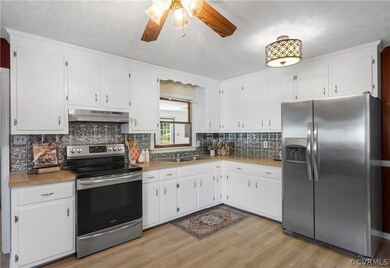 Kitchen featuring light wood-type flooring, white