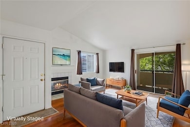 Living area with vaulted ceiling, wood finished fl