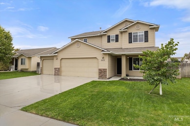 Traditional home featuring driveway, an attached garage, and stone siding