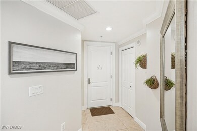 Entryway featuring crown molding and light tile pa
