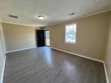 Unfurnished room with a textured ceiling, ornament
