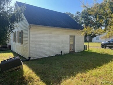 View of side of home with a yard
