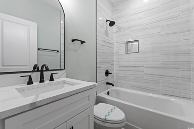 Bathroom with toilet, shower / bathtub combination