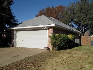 View of home's exterior with brick siding, roof wi
