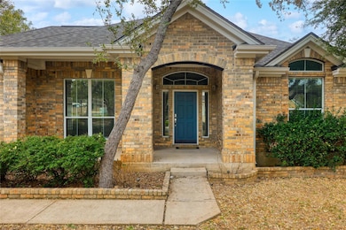 Entrance to property featuring a shingled roof, b