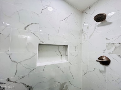 Full bath with a tile shower niche