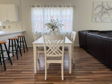 Dining room with wood-style floors, and abundance of natural light