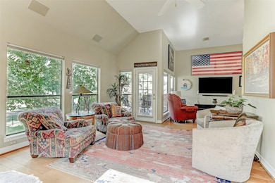 View of the living room looking back towards the balcony/deck area with the den/flex space on the right. Perfect flow for entertaining family & guests.