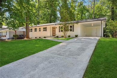 Ranch-style home featuring driveway, a front yard, a carport, and brick siding