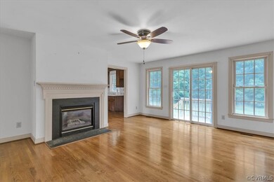 Unfurnished living room featuring ceiling fan, a h