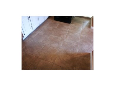 Tile floor in kitchen, dining area, laundry and ba