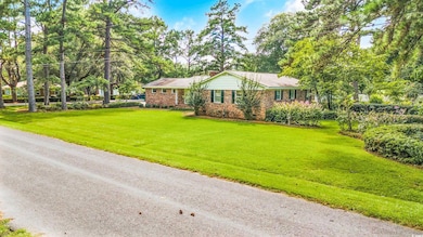 Ranch-style house featuring a front lawn