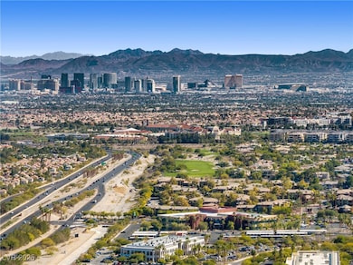 Aerial overview of property's location with a mountainous background and nearby urban area