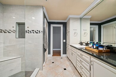 The extra long bathroom features a custom walk-in