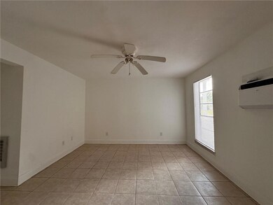 Living area with natural light and ceiling fan