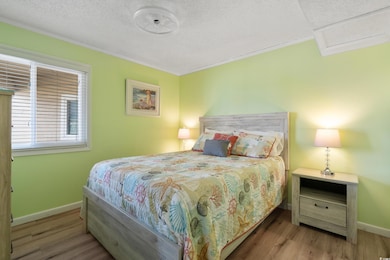 Bedroom featuring light wood-type flooring and a t