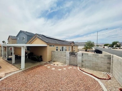View of side of property with solar panels, a gate
