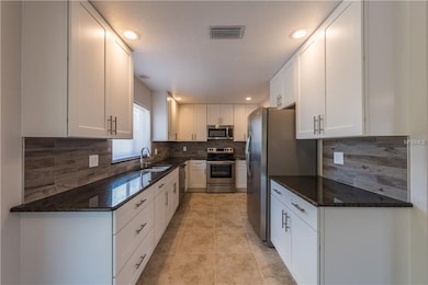 Beautifully upgraded kitchen with tile floor and b
