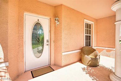 Doorway to property with stucco siding and covered porch