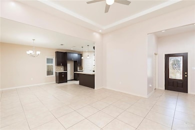Unfurnished living room with light tile patterned floors, a chandelier, recessed lighting, and a ceiling fan