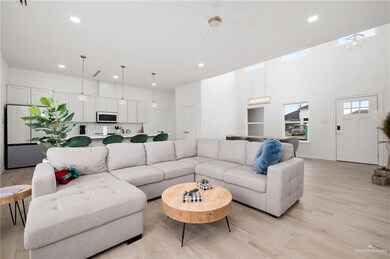 Living room featuring light wood-type flooring and ceiling fan