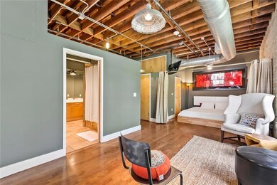 Living area with baseboards and wood finished flo