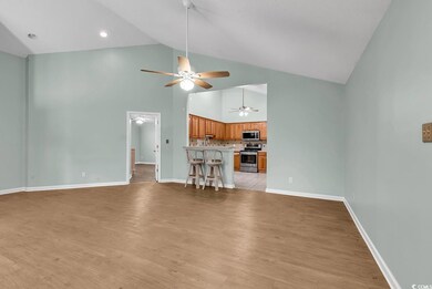 Unfurnished living room with ceiling fan, high vaulted ceiling, and light hardwood / wood-style floors