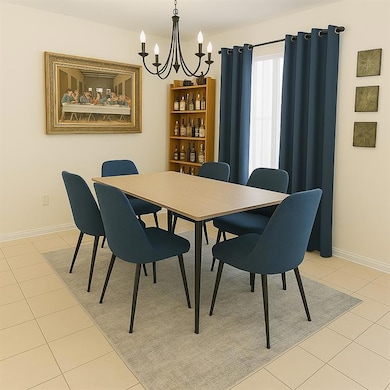 Dining room featuring a chandelier and light tile