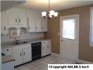 The cozy eat-in kitchen features tile flooring.