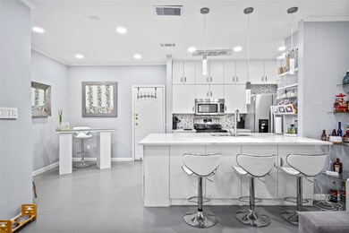 This stylish kitchen features crisp white cabinetr