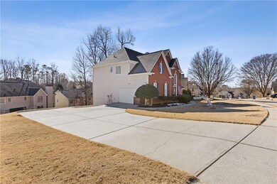 View of side of property featuring a yard and a ga