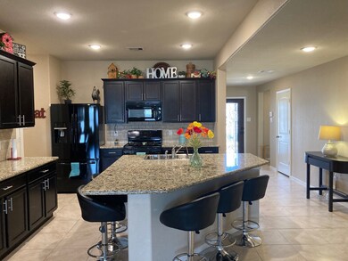 THE CUSTOM KITCHEN DESIGN BOAST A LARGE ISLAND THAT OPENS TO THE FAMILY ROOM