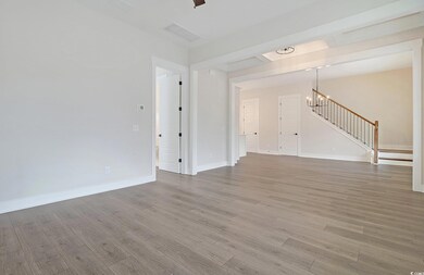 Unfurnished living room with a chandelier and wood
