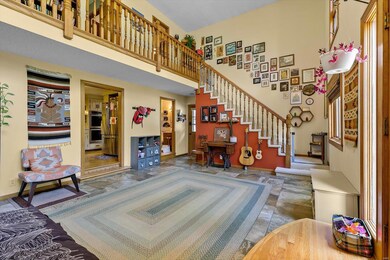 Open stairway to second floor with balcony overlooking family room