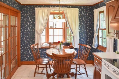 The dinette features a bay window with backyard vi