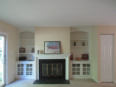 Great room with built-in bookcases and wood burnin